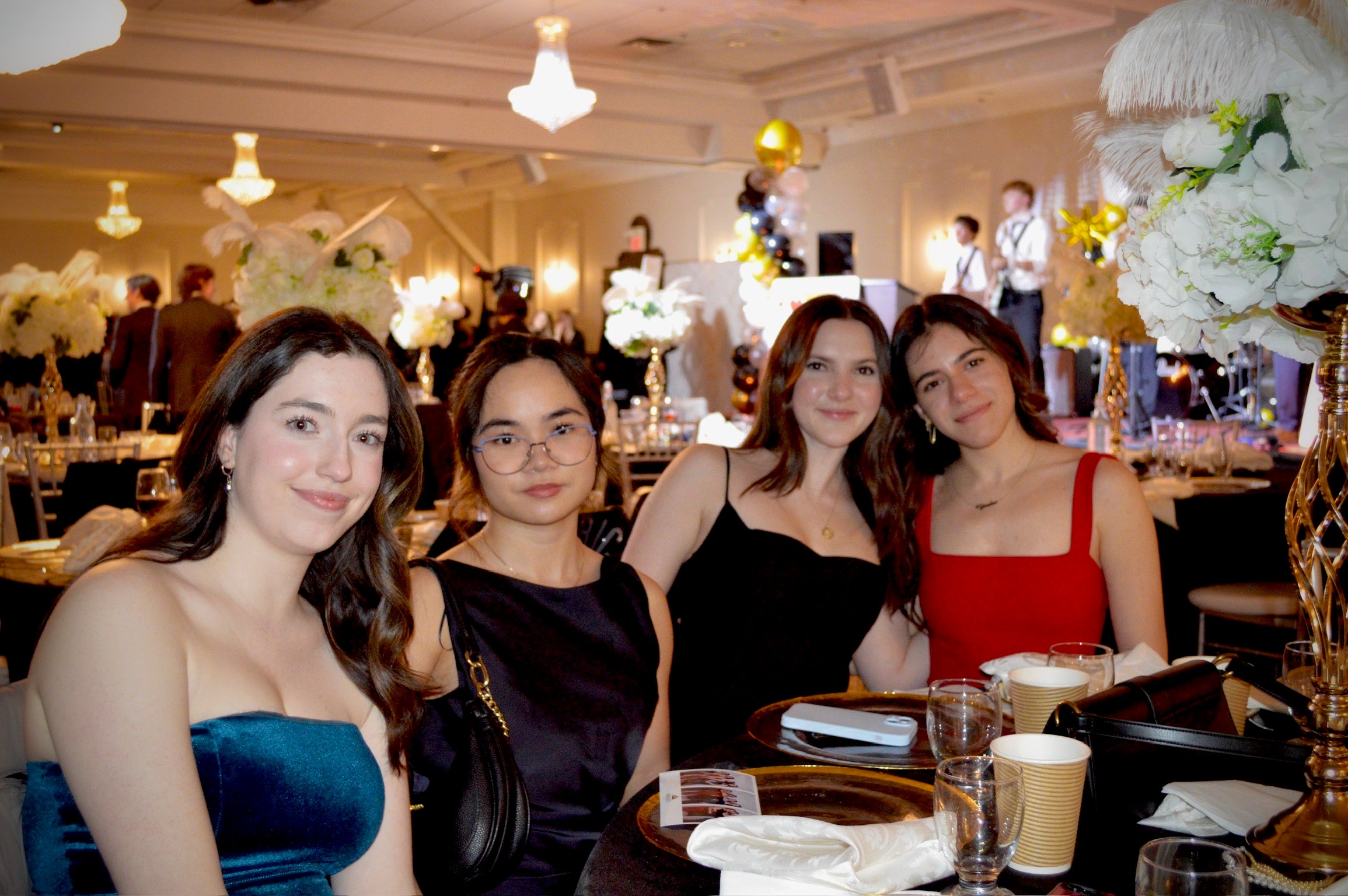 Four LANG students at a formal gala dinner